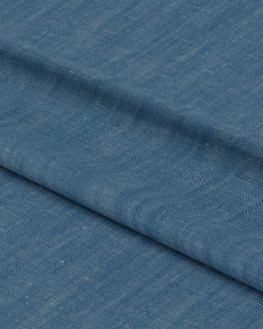 Close-up of blue fabric with a subtle pattern