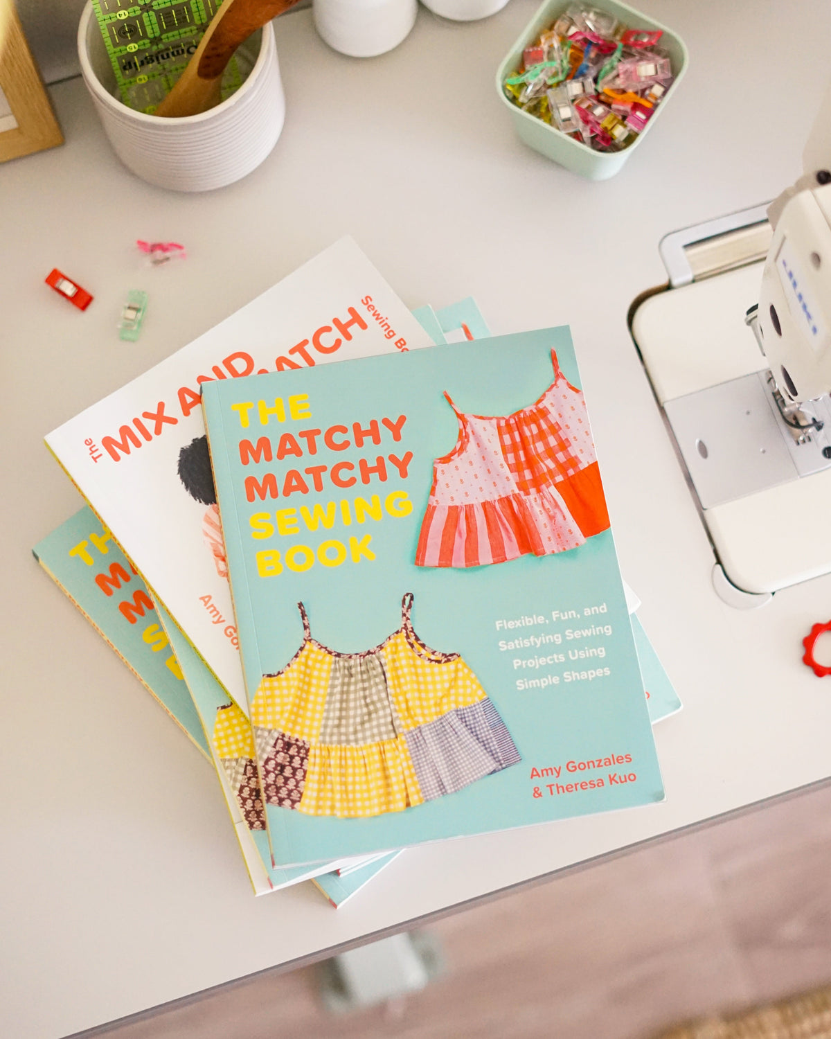Sewing books on a table with a sewing machine and materials