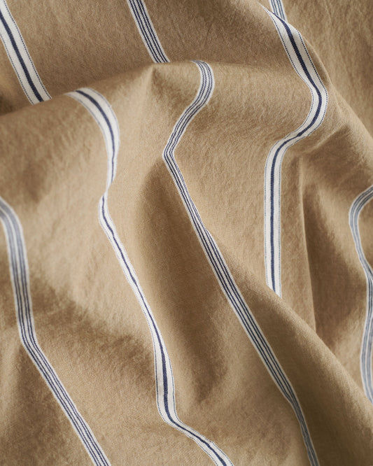 Close-up of beige fabric with blue stripes