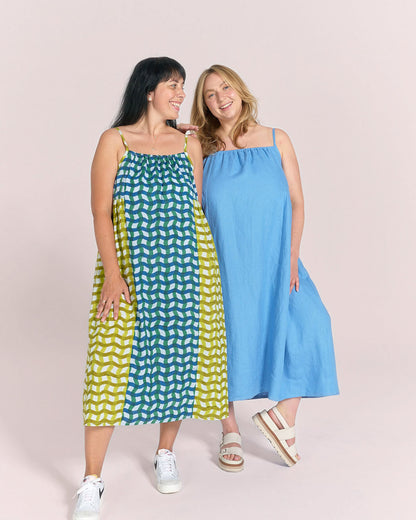 Two Models wearing Schoolhouse Sundress made in blue Cloud Linen and patchwork stripe cotton with gathered neckline and spaghetti straps