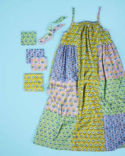 Flat lay of sundress sewn in cotton block print with colorful patchwork fabrics